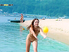 Nude beach teens playing volleyball